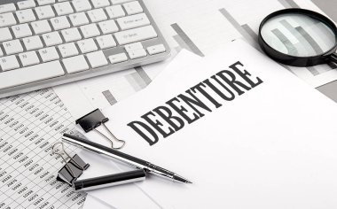 Grafikli ve klavyeli bir kağıt üzerinde DEBENTURE metni, iş konsepti