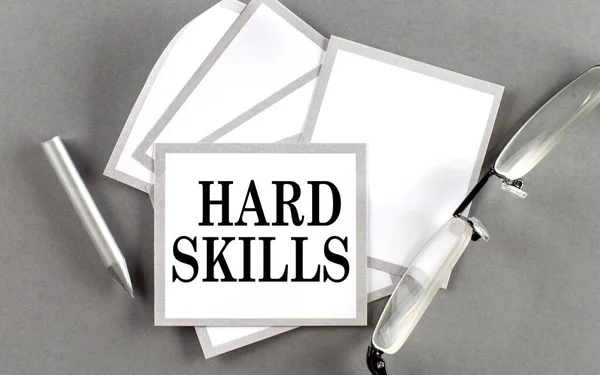 HARD SKILLS text written on sticky with pencil and glasses