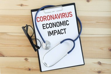 Kitabın üzerinde 'CORONAVIRUS ECONOMIC IMPACT' yazılı bir görüntünün düzlüğü