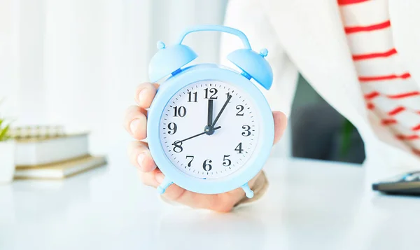 alarm clock in hand. Time management. Time take action. Deadline concept.