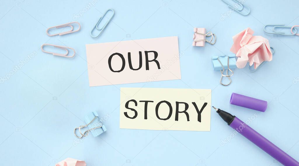 Text Our Story on a white sticker with office stationery background. Flat lay on business, finance and development concept