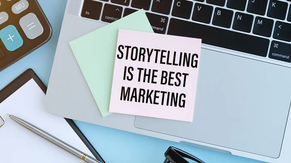 Storytelling is the best Marketing - written on a notebook with a pen.