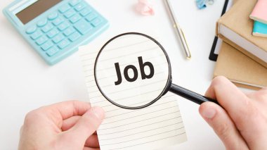 Job vacancy, looking for a job concept. Hand holding magnifying glass and speech bubble with text JOB.