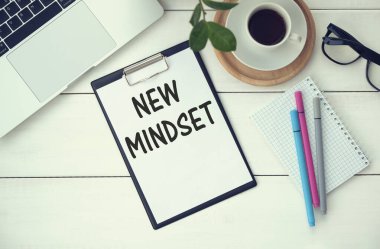 New mindset words letter, written on notepad, work desk top view. Motivational self development business typography quotes concept.