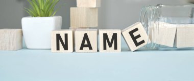 text name written on wood cubes that lie on wood cubes. High quality photo