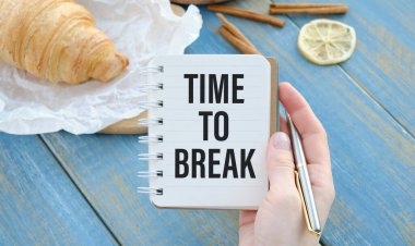 TIME TO BREAK. text on white notepad paper. on a wooden table