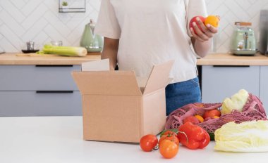 Kıyafet bağışıyla gülümseyen genç kadın, en az sayıda ürün..