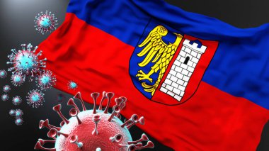 Gliwice ve covid salgını. Virüs Gliwice bayrağına saldırıyor. Virüs salgınıyla mücadele sembolü olarak.