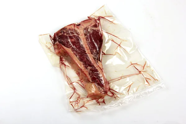 Raw Fresh Beef Bone Steak Plastic Package Isolated White Background — Zdjęcie stockowe