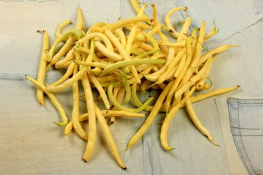 Fresh yellow beans on a wooden table background