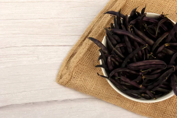 Purple Wax Snap Beans on the white background, Organic fresh beans