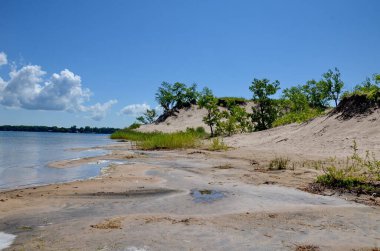 Dunes Beach sand dunes at Sandbanks Provincial Park in Ontario, Canada.   Sandbanks is the largest baymouth barrier dune formation in the world. It is located on Lake Ontario.