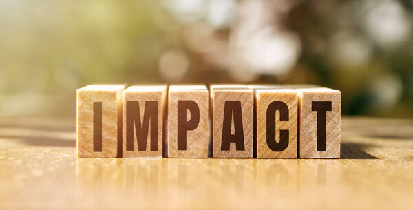 Impact word made of wooden cubes with black letters