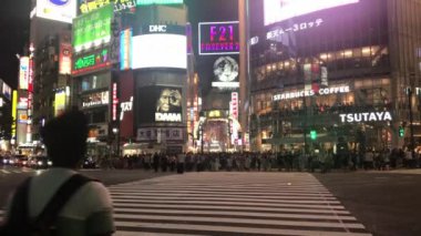 Tokyo, Shibuya, Japan - July 27, 2019: Footage of the Shibuya intersection at night, one of the most busy crosswalks in the world.