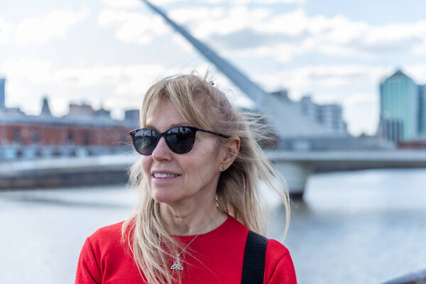 Mature woman with glasses looking at the horizon in Buenos Aires. Selective focus
