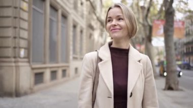 Şehirde yürüyen orta yaşlı güzel bir kadın. Mutlu ve gülümseyen Rus bayanın portresi.