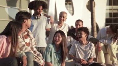 Multiethnic group of gen z teenager friends having fun, laughing and chilling