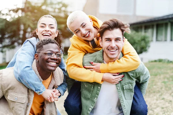 Group Of Happy Young Student couple Friends Piggyback, having fun and laughing in the University campus. Love and friendship — Stock Photo, Image