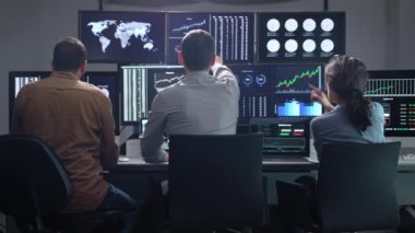 Excited team of business investors celebrating success in trading. Exchange office with monitors and rates, profit investment and earnings