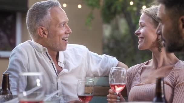 Mature Couple Enjoying Romantic Conversation Garden Party Summer Evening Drinking — 图库视频影像