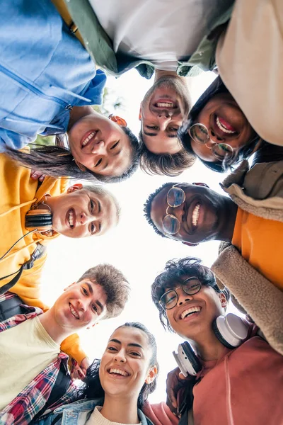 Young student friends having fun hugging together and looking to the camera