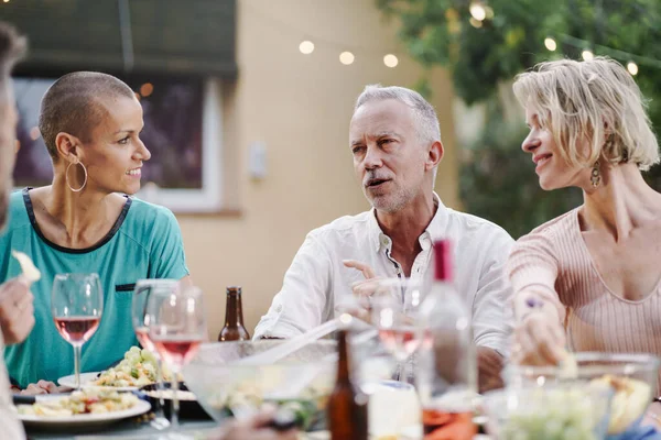 Mature Man Husband Talking Female Friend Wife Summer Dinner Home – stockfoto