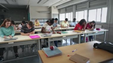 Teenager students taking exam at College, preparation course for University