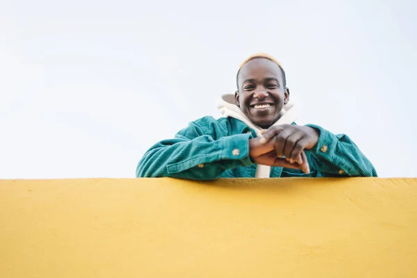 Friendly Young African Man Looking Camera Yellow Wall – stockfoto