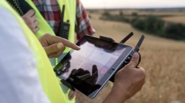 Tablet ekran ve uzaktan kumandalı dron uçuş uygulaması rüzgar elektrik türbinlerini araştıran mühendisler tarafından çalıştırılıyor. Bakım işleri için hava teknolojisi 