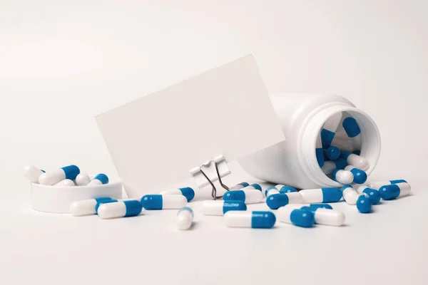 Closeup Blank White Business Card Blue White Pills Spilling Out — 图库照片