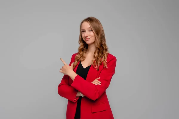 Confident Young Woman Points Finger Upper Left Corner Showing Advertisement — Photo
