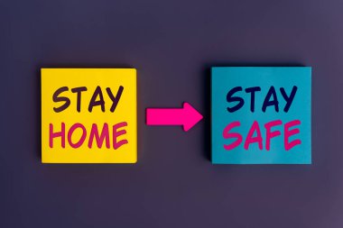 Stay home, Stay safe - concept text on colorful sticky notes. Stay at home and be safe. Self isolation and quarantine campaign to protect yourself and save lives. New normal behavior
