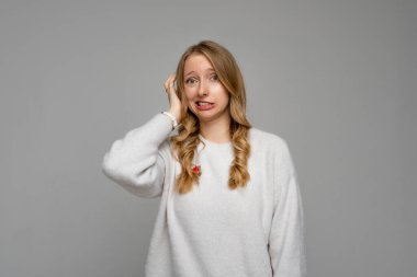 Eyvah, eyvah. Utanmış genç sarışın bir kadının portresi, el ele tutuşmuş ve garip bir ifadeyle suratını buruşturmuş, suçlu olarak ve kimsenin onun hatasını bilmediğini umarak. Duygular konsepti