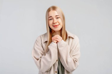 Mutlu genç bir kadın şükran jestleri yapar. Avuçlarını kalbime bastırır. İltifatlardan memnun hisseder. Vücut dili ve gerçek duygular kavramı