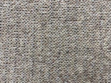 Yulaf ezmesi örülmüş yün dokusu. Kaba örgü ya da kumaşın arka planı. Örgü desenli arkaplan.