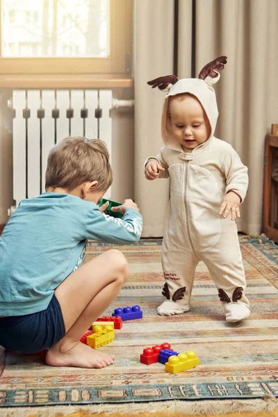 Funny Baby Boy Wearing Deer Bodysuit Elder Brother Playing Construction — Stock Photo, Image