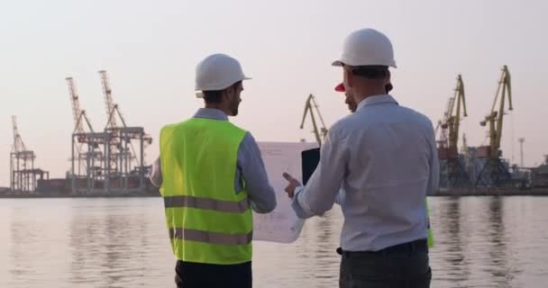 Men discuss construction issues with delineation and tablet — Stock Video