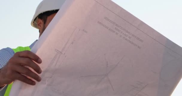 Engineer checks drawing of cranes under renovation closeup — Stock Video