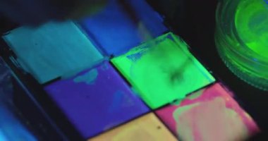 Parlak renkli neon boya paleti Karanlıkta parlıyor
