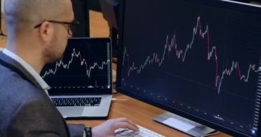 Financial counselor works with data from stock exchange
