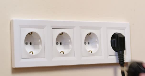 Man Inserts Plug Domestic Appliance White Socket Installed Beige Wall — Stock Video