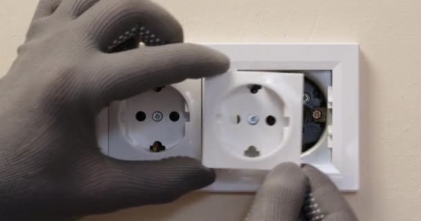 Man Protective Cotton Gloves Installs New Modern Socket Beige Wall — Wideo stockowe