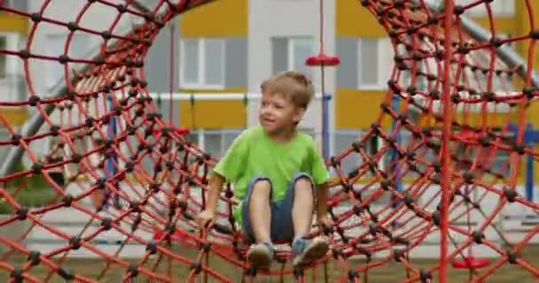 Preschooler Boy Plays Alone Jumping Red Ropes Attraction Happy Child — Vídeo de stock