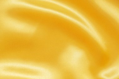 Yumuşak dalga dokusu arka planına sahip soyut lüks altın kumaş