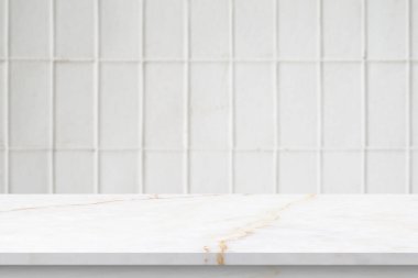 Boş beyaz mermer masa üstü. Duvarın arka planında bulanık fayans var.