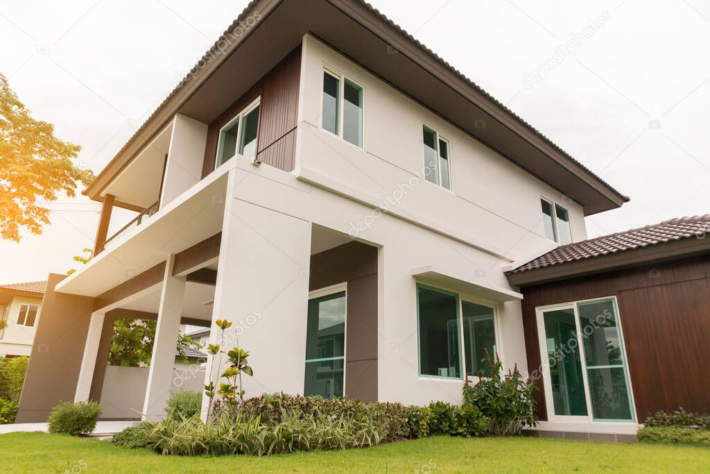 Beautiful modern house exterior with green grass