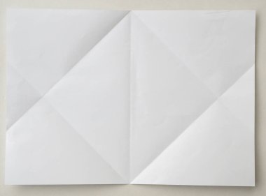 White folded and wrinkled paper on white background