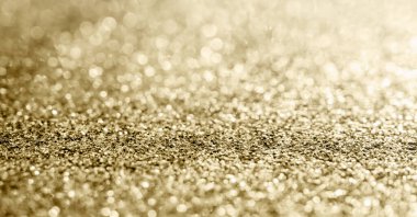 Soyut altın parıltısı arkaplan ile bulanıklaştırılmış