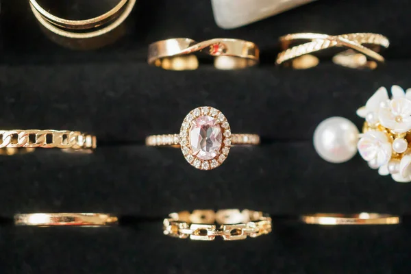 Gold jewelry diamond rings show in luxury retail store display showcase