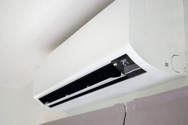 Air conditioner on white wall room interior background
